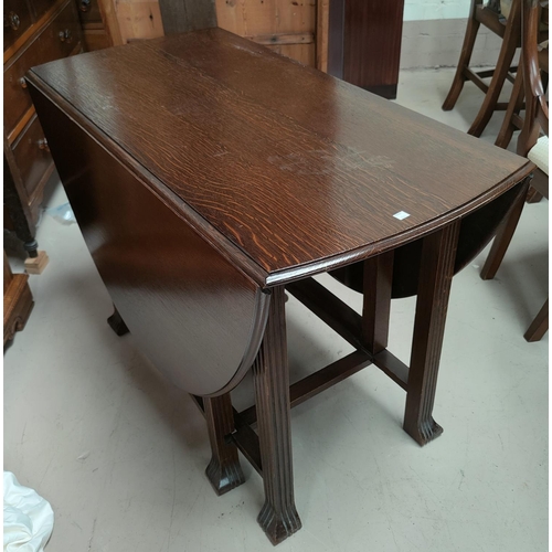 700 - A 1930's oak dining table with oval dropleaf top, on square reeded legs; a set of 5 (4 + 1) ladder b... 