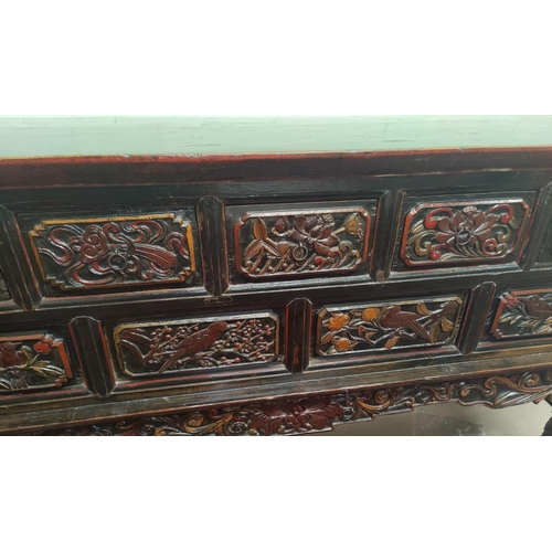 702 - A late 19th/early 20th century Chinese unusual altar table, carved and lacquered with scroll end top... 