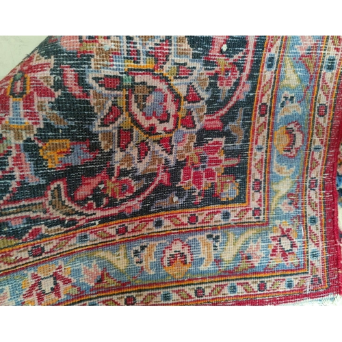 712 - A mid 20th century Turkoman carpet, floral motifs on red ground multi-coloured, 9.5' x 12.5' approx