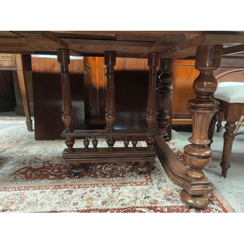 728 - A late 19th century French provincial walnut extending dining table, on turned and fluted legs, 3 sp... 