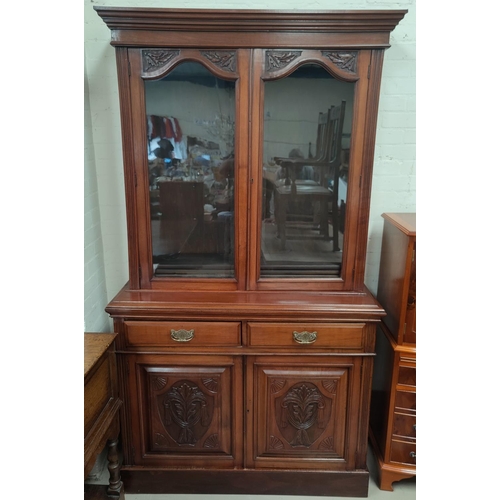 730 - An Edwardian full height walnut bookcase with twin glazed doors, 2 drawers and double cupboard under... 