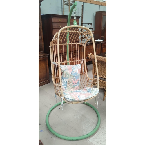 758 - A 1960's cane hanging chair on stand