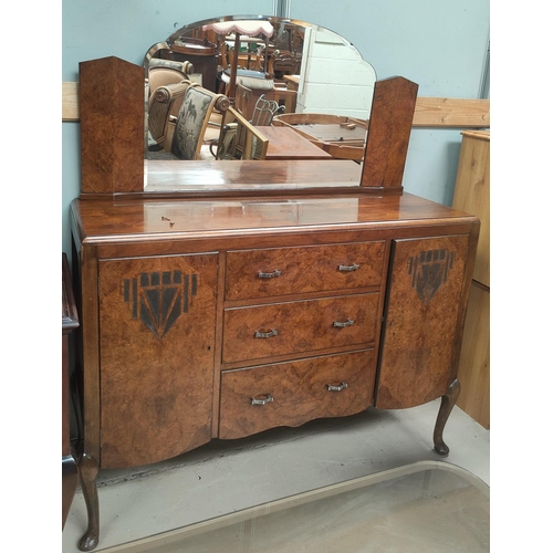 775 - A 1930's Art Deco burr walnut mirrored back sideboard with two cupboards and three central drawers, ... 
