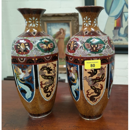 80 - A Chinese pair of cloisonné vases of hexagonal form, decorated with mythical beasts in reserve panel... 