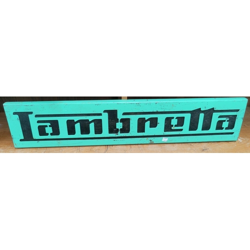 81A - A vintage Lambretta advertising sign with green painted metal sign with black wood painted backgroun... 