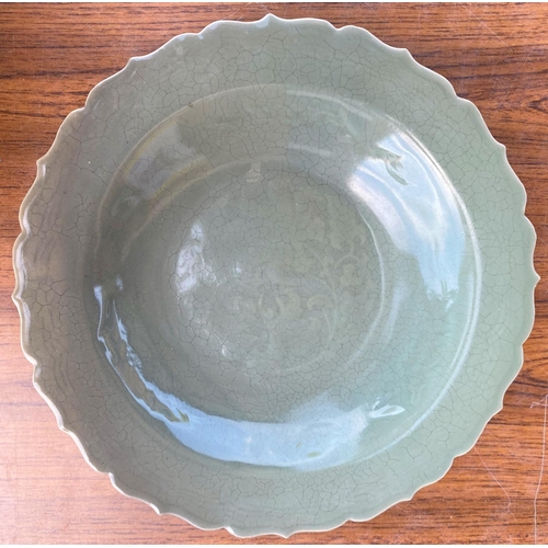 445a - A Chinese celadon glaze dish with scalloped border, diameter 31cm and a carved Chinese hardwood figu... 