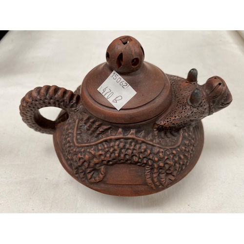 470B - A Chinese Yixing teapot with relief dragon form with head as spout, mark to base and two Chinese ped... 