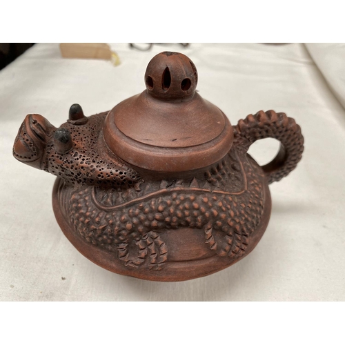 470B - A Chinese Yixing teapot with relief dragon form with head as spout, mark to base and two Chinese ped... 