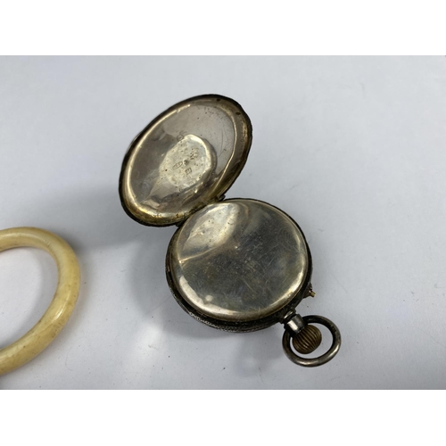 505 - A baby's teething ring with silver bell attached, marked 'BABY' in blue enamel, Birmingham 1902 and ... 