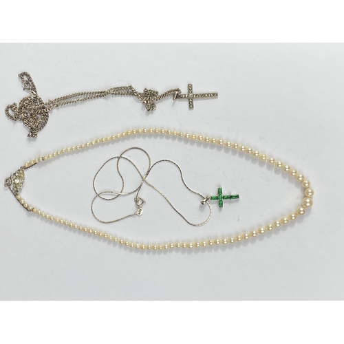 507 - A cultured pearl graduating necklace with silver clasp and safety chain, length 45cm and 2 stone set... 