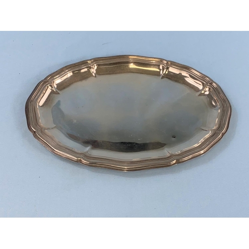 571A - An oval white metal platter with ribbed decoration and moulded wavey border, stamped 835, 6.5oz, 202... 