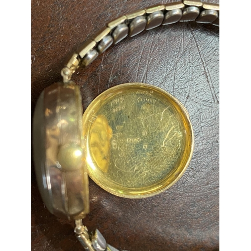 503 - A lady's 9 carat wristwatch with import marks for Glasgow 191, on Excalibur gold plated expanding st... 