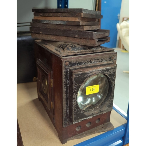 128 - A brass and mahogany magic lantern (incomplete); a metal magic lantern case; 7 magic lantern coloure... 