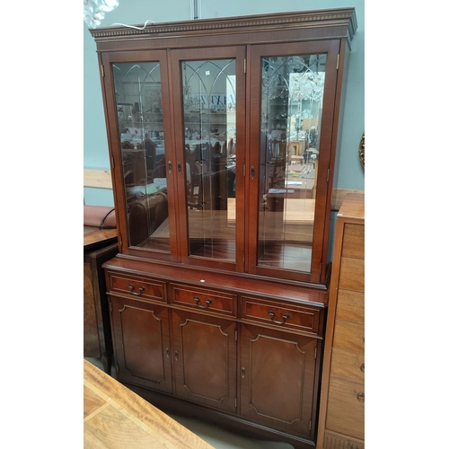 634 - A reproduction mahogany wall unit with 3 glazed doors over 3 drawers & 3 cupboards