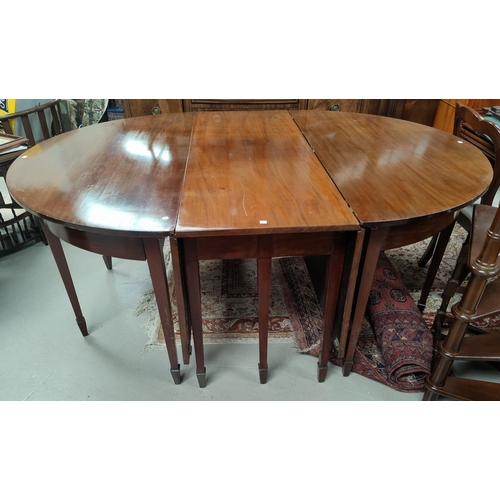 643 - A late Georgian mahogany D-end dining table with central drop leaf section and two detachable D-ends... 