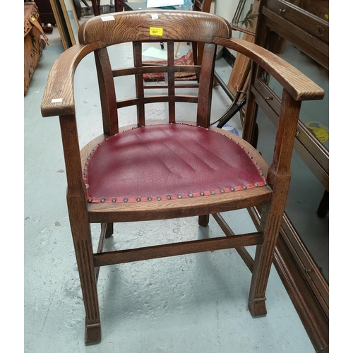 661 - A 1930's oak captain's style armchair with lattice work back, studded leather effect seat