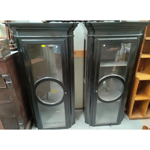 679 - A pair of modern ebonised tall thin display cabinets with single glazed doors in the French manner h... 