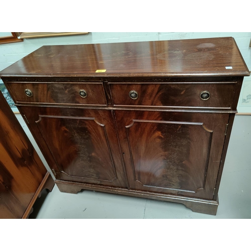 686 - A reproduction side cabinet of two drawers and two cupboards below