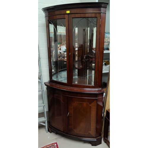 691 - A reproduction mahogany full height corner cupboard with glazed cupboard above with mirror back