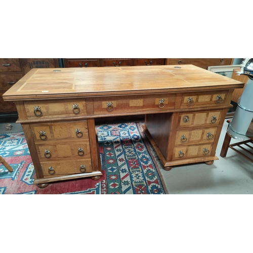 695 - A modern lightwood pedestal desk with 3 frieze drawers, 1 deep drawer to side and 3 drawers to the o... 