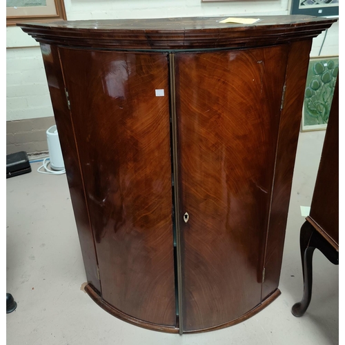 714 - A mid Georgian figured mahogany corner cupboard with bow front and plain moulded cornice, 75 x 93 x ... 