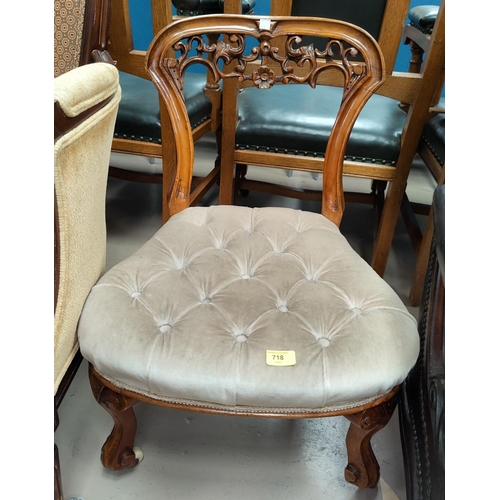 718 - A Victorian walnut nursing chair with buttoned down overstuffed seat