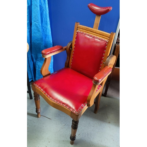 772 - An Edwardian barber's shop chair with red leather effect upholstery, adjustable sloping back stamped... 