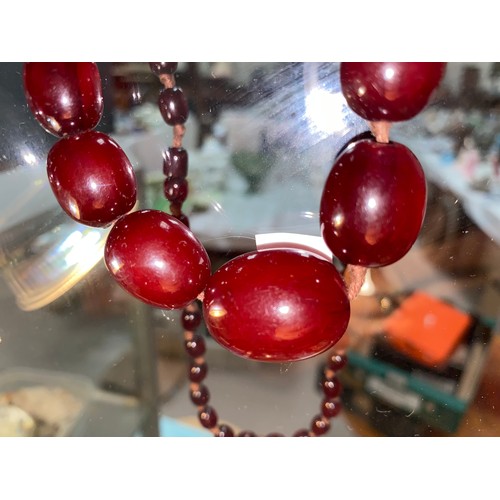 500D - A cherry Bakelite amber coloured graduating bead necklace, largest bead approx 26mm, , length 80cm, ... 