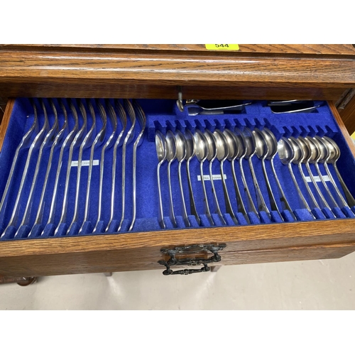544 - An Oak canteen on stand of silver plated cutlery with hinged lid, drawers below