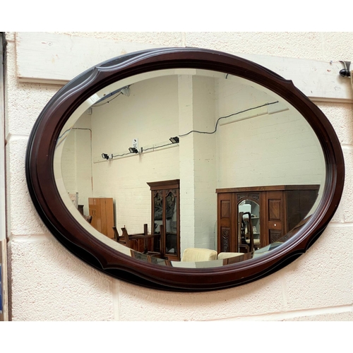 693 - A mahogany framed oval mirror