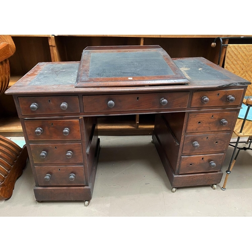 737 - A Victorian mahogany Dickensian style desk with raised slope front writing surface, the kneehole bas... 