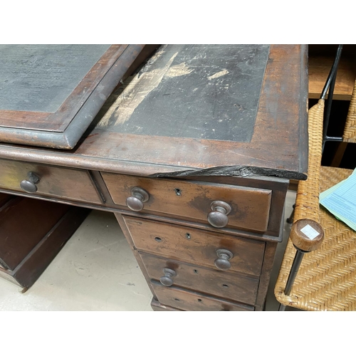 737 - A Victorian mahogany Dickensian style desk with raised slope front writing surface, the kneehole bas... 
