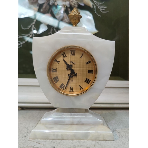 142A - An Imhoff marble effect cased mantel clock with Swiss level escarpment movement