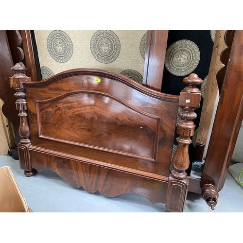 680 - A mahogany half tester bed with traditional columns on foot. A cream headboard with Greek style desi... 