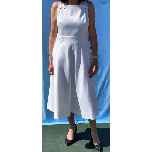 225 - An ESCADA white woven effect pinafore dress with cross strap back. with original labels (size 12)