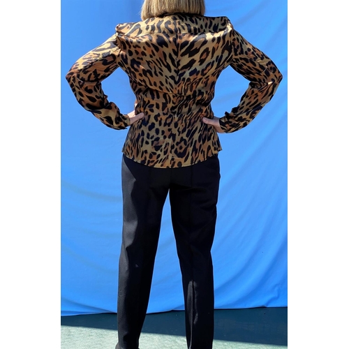 234 - Escada - a leopard print blouse, size 10; Escada black trousers, size 10, side zip detail to each si... 