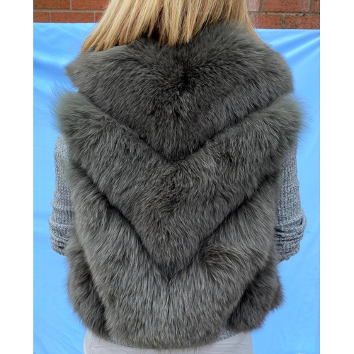 277 - A grey fox fur gilet with belt and another black fox fur gilet