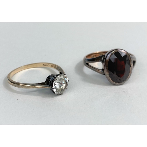 520 - A 9 carat hallmarked gold ring set oval garnet; a yellow metal ring set clear stone, stamped 9ct Cir... 