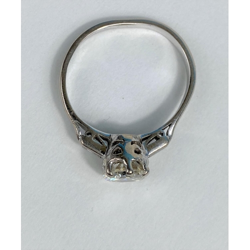 523 - A diamond set ring with central bright cut stone and small baguette cut stone to either shoulder, on... 