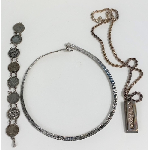 525 - A silver ingot pendant; a silver 3d bracelet; etc.