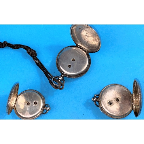 531 - Three chased white metal fob watches, key wound, with gilded enamel dials
