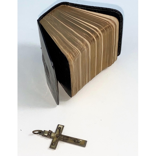 598 - A miniature book of Common Prayer with hallmarked silver cover with angels in relief and a crucifix ... 