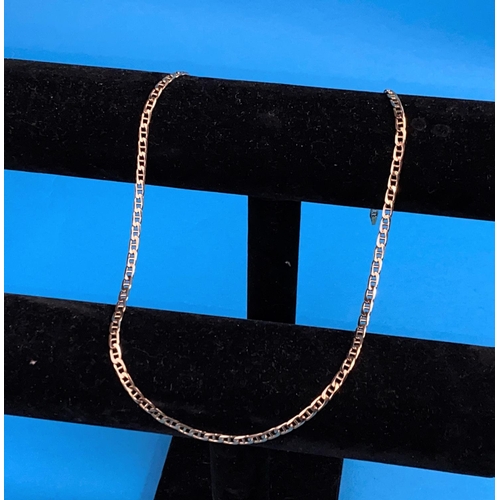 558 - A yellow metal neck chain formed from flattened curb links st 375 20.5gm