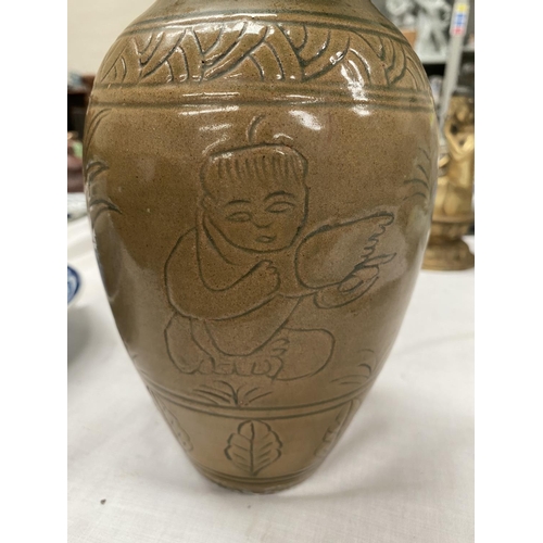 348E - A Chinese stone ware baluster vase with tea dust coloured ground with incised decoration height 23cm