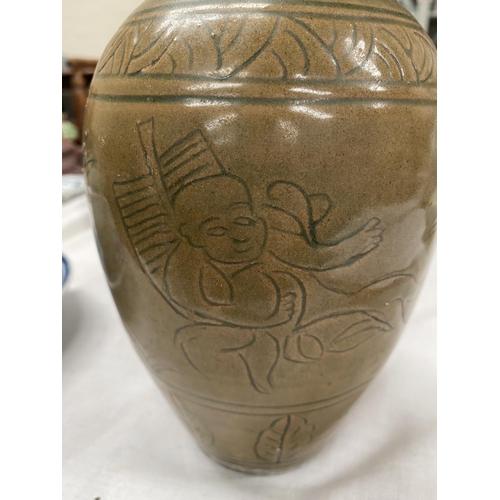 348E - A Chinese stone ware baluster vase with tea dust coloured ground with incised decoration height 23cm
