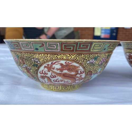 347C - A pair of Chinese famille jaune rice bowls with 4 dragon panels to exterior, central dragon to inter... 