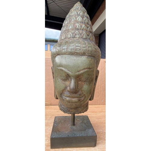 354b - A large south east Asian Khmer style carved stone Buddha head on stand, height 42cm