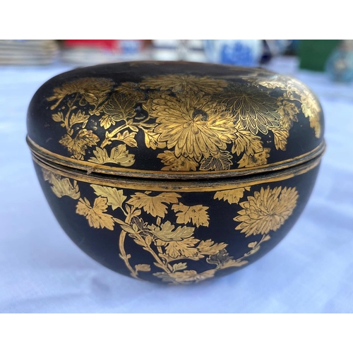 375 - A Japanese Meiji period gilt and matt black metal lidded pot with finely detailed decoration of chry... 