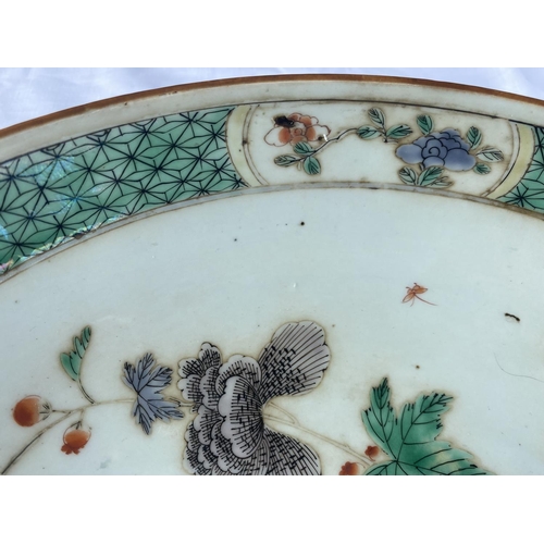 345D - A Chinese famille verte charger decorated with plants and insects, diameter 33cm