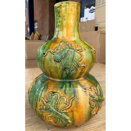 353 - A Chinese yellow and green double gourd vase with dripware glaze and decoration in relief, height 29... 